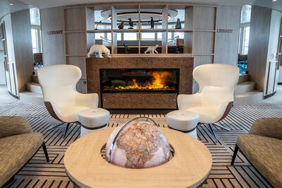 Cozy seating in front of the fireplace on the NatGeo Endurance.