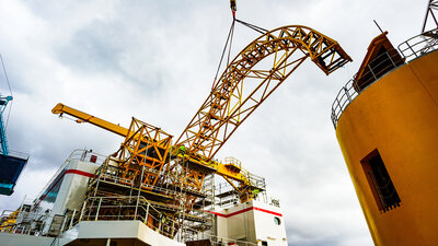 Hoisting the loading arm into place.